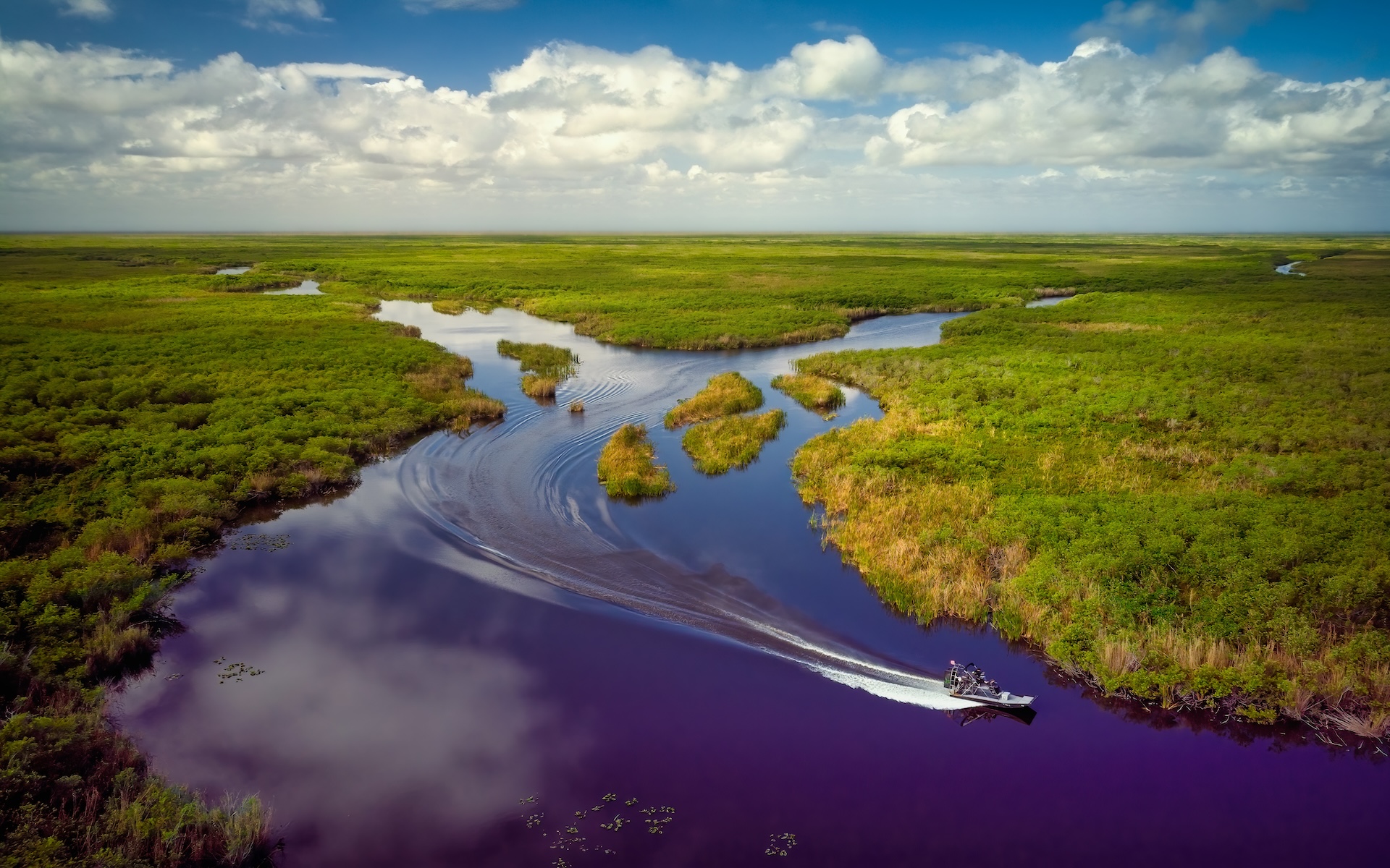 Overhead view of a boat on the water in the Florida Everglades.