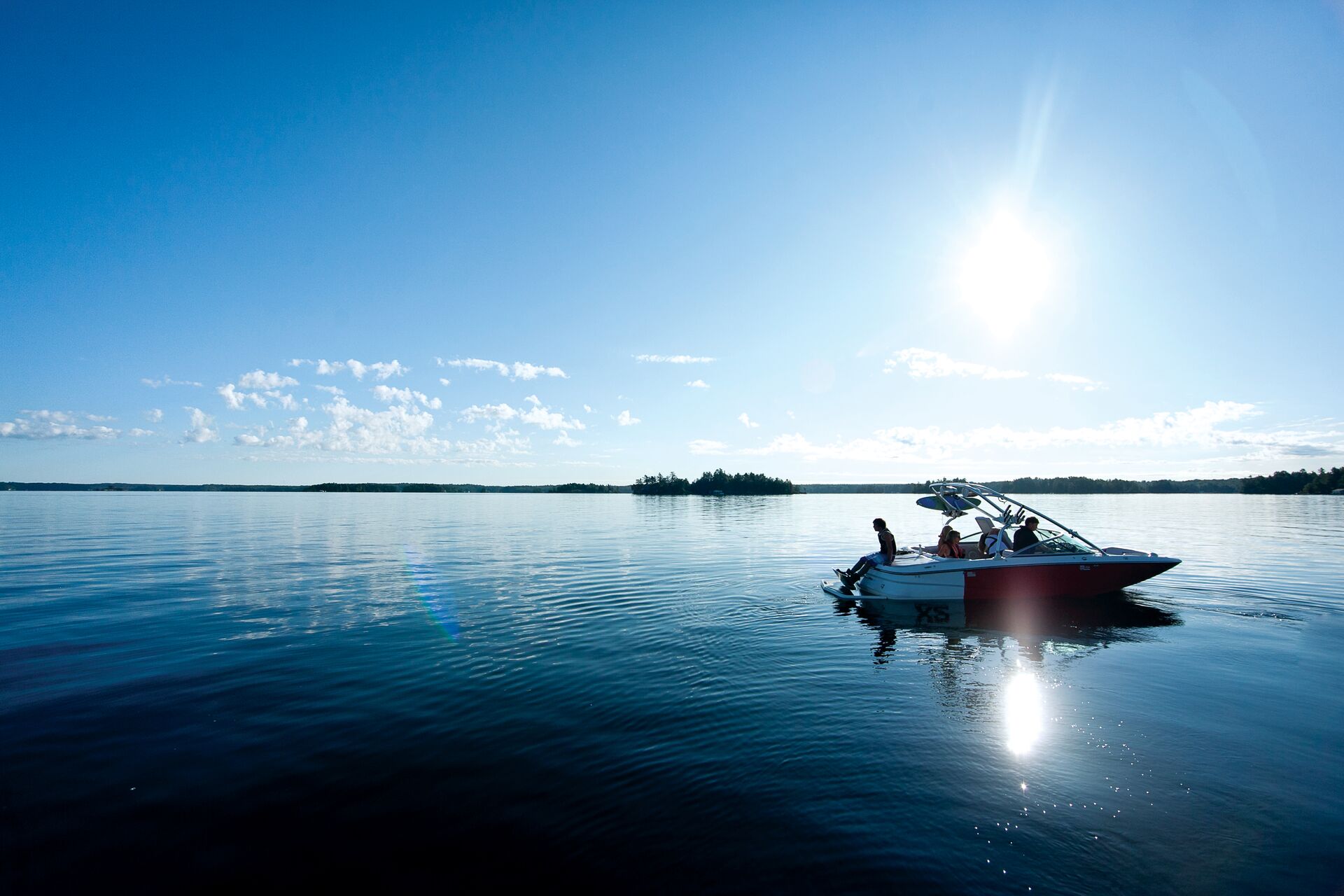 A boat floats on the water in the distance, how does a boat float concept. 