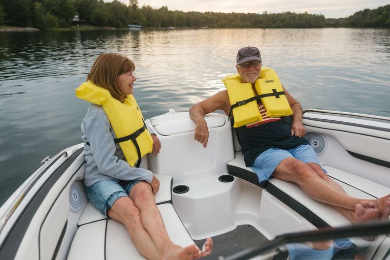  Two people in yellow life vests, how to avoid seasickness on a small boat concept