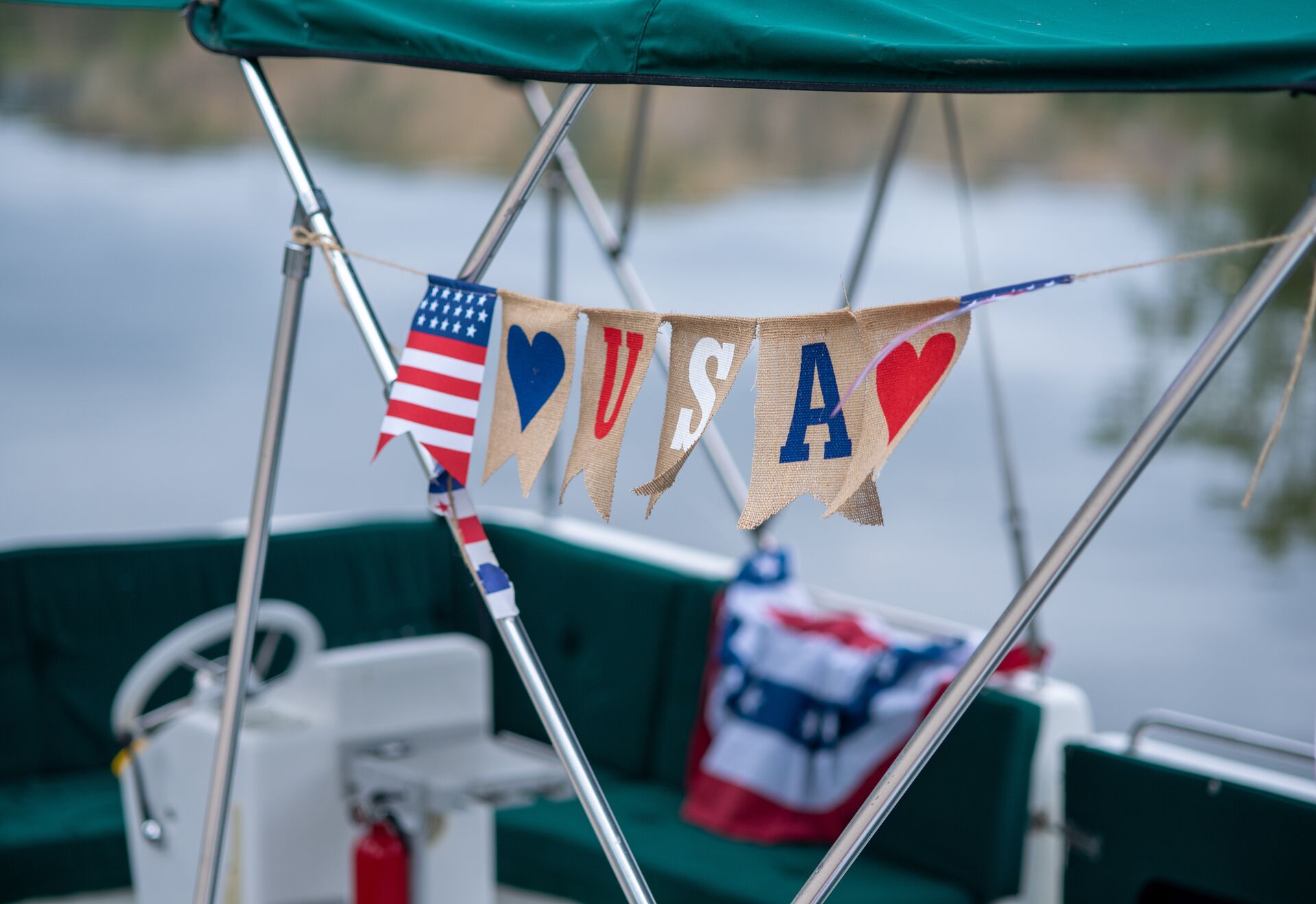 Flags spelling USA on a boat, avoid boating and alcohol for July 4th concept.