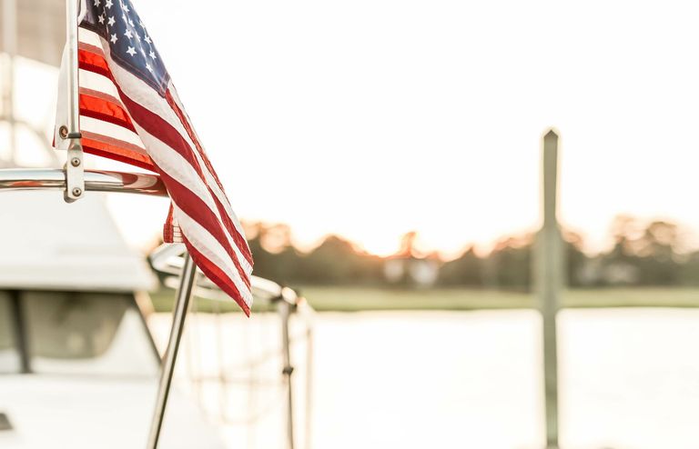 An American flag on a boat, understand boat drinking laws for July 4th concept. 