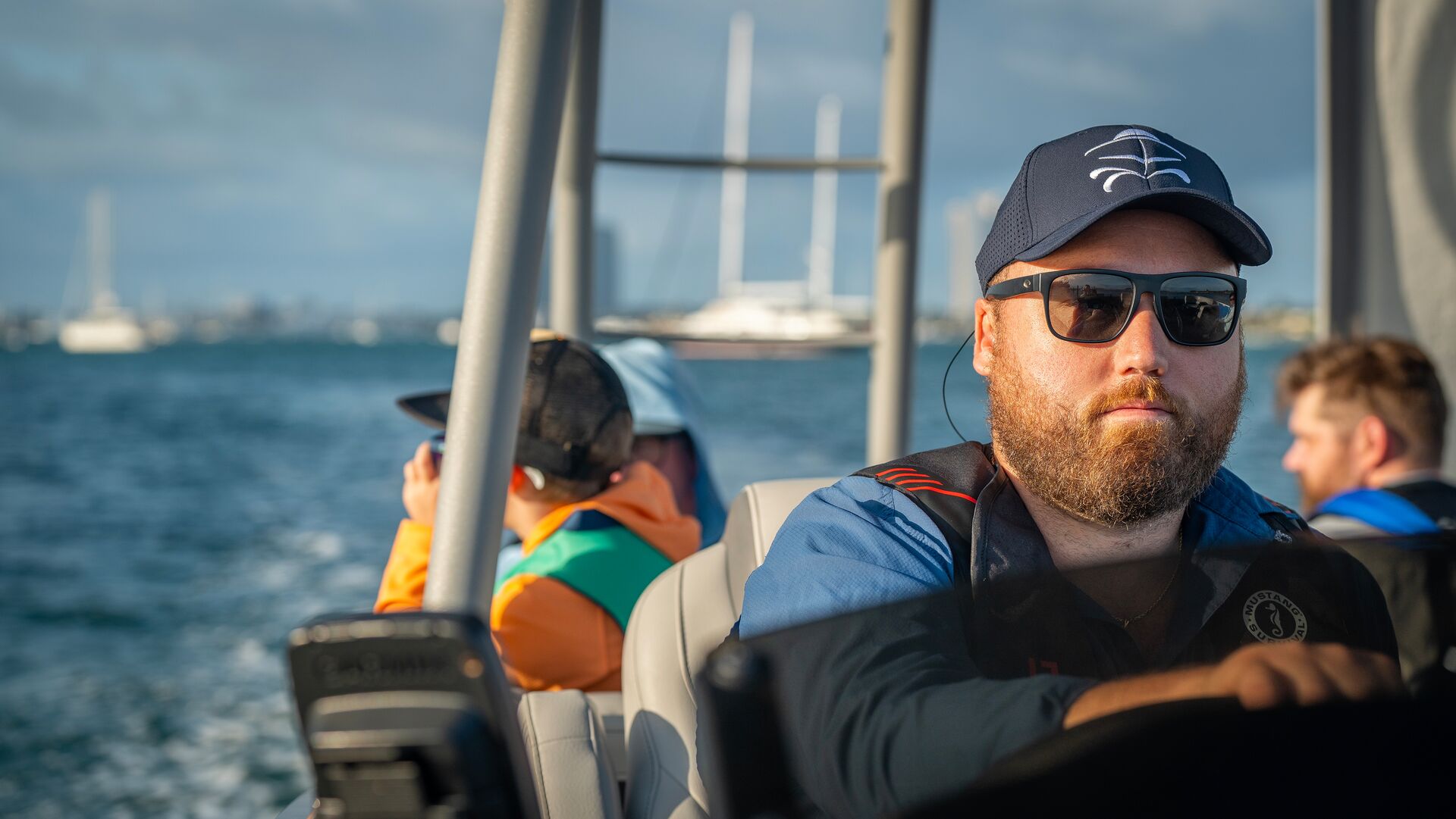 Man driving boat full of people, know how to call for help on a boat concept. 
