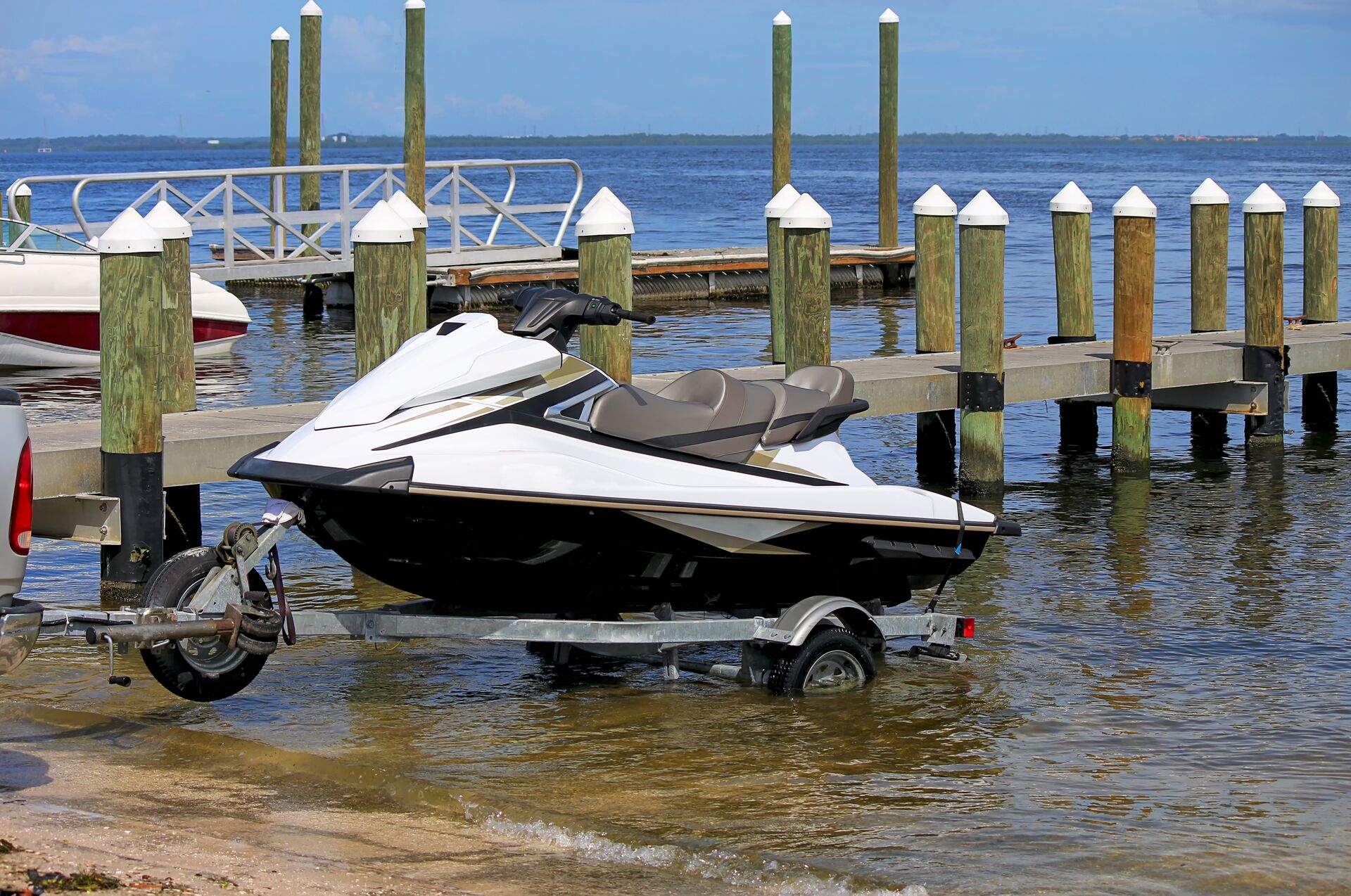 Jet ski on a trailer entering water, how to start jet ski concept. 