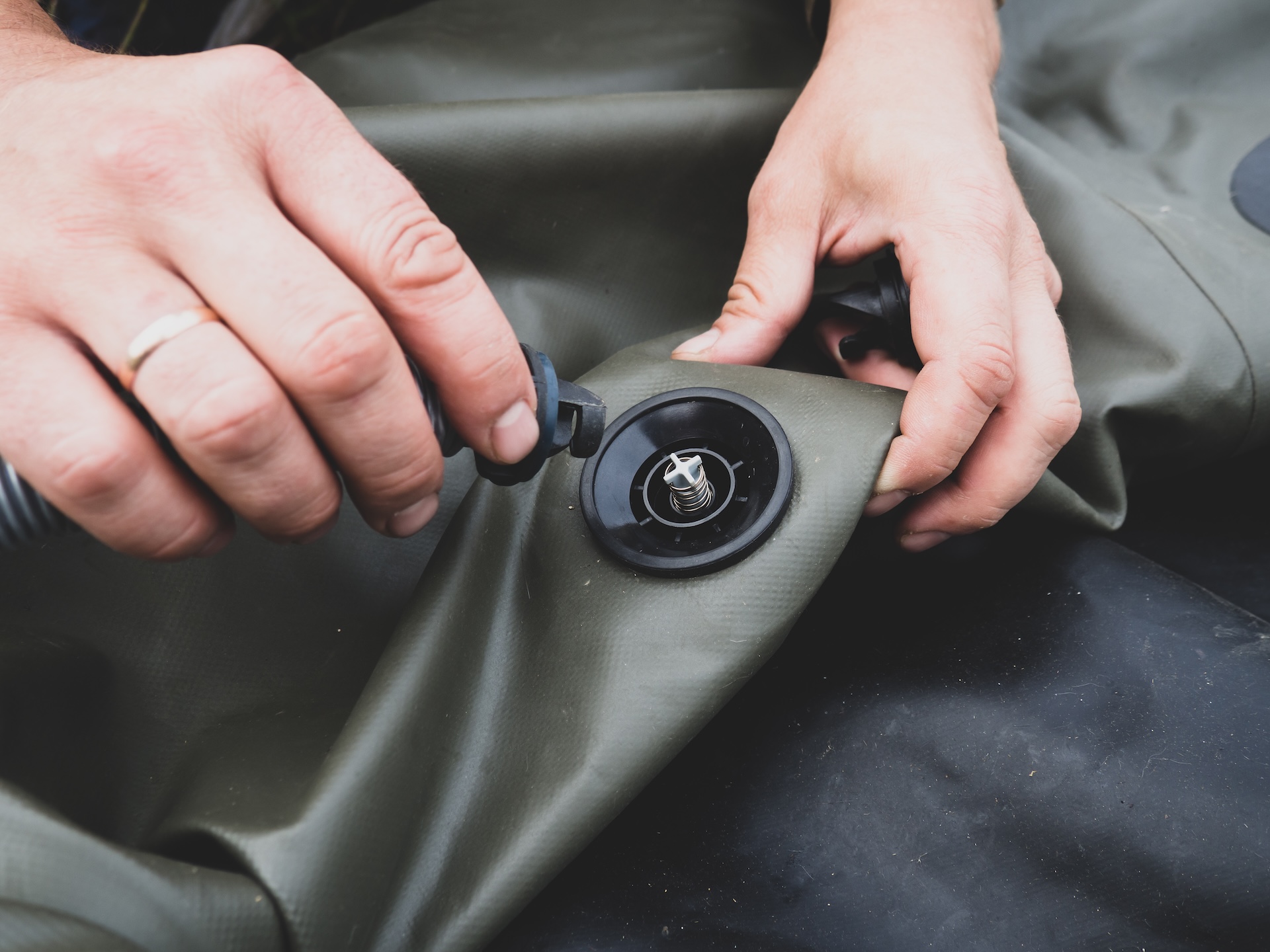Close-up of putting air into an inflatable boat.