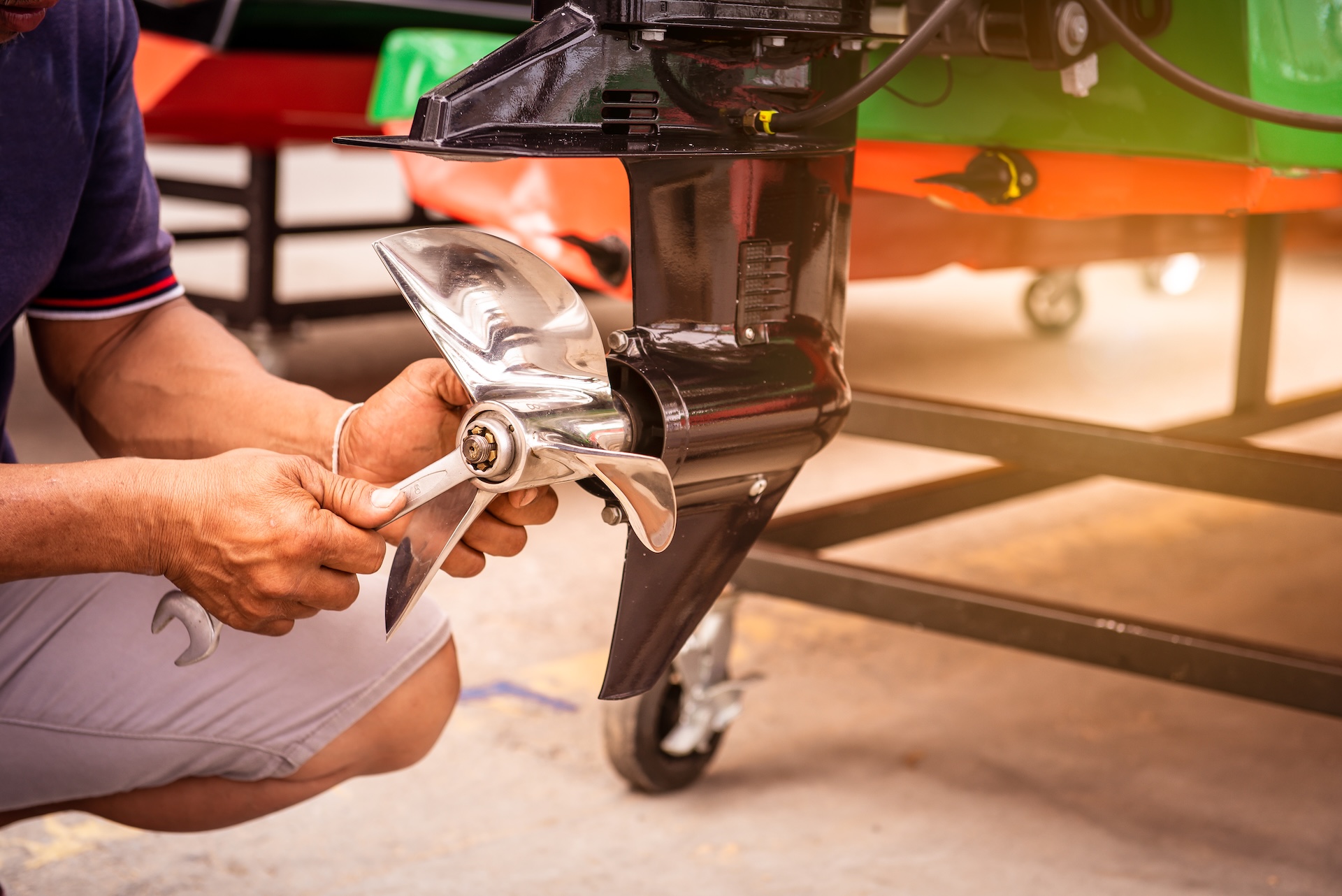 Close-up of person working on boat propellers.
