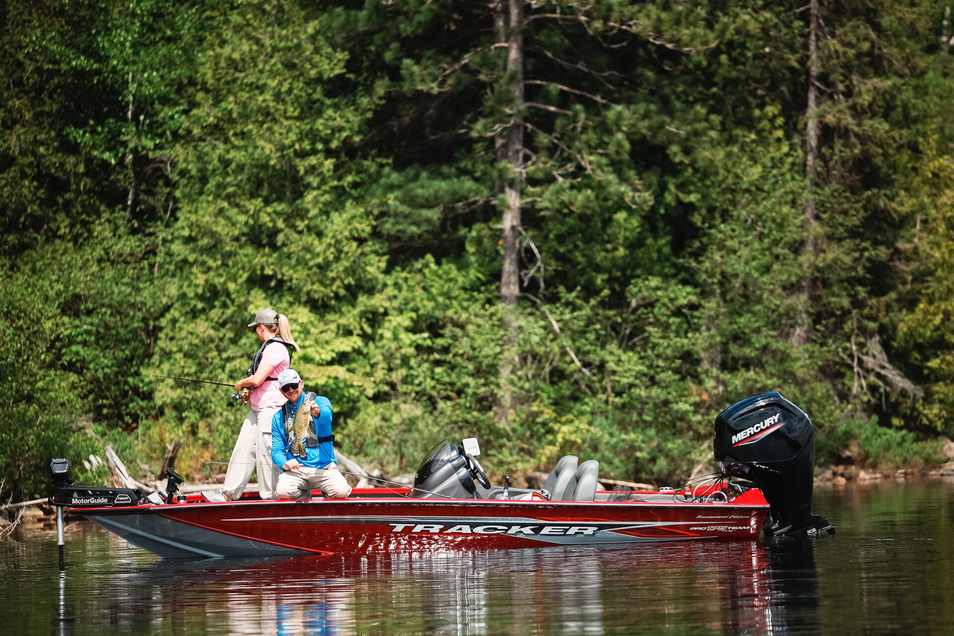 Man and woman catching fish on fishing boat on the water, boating in shallow water concept.