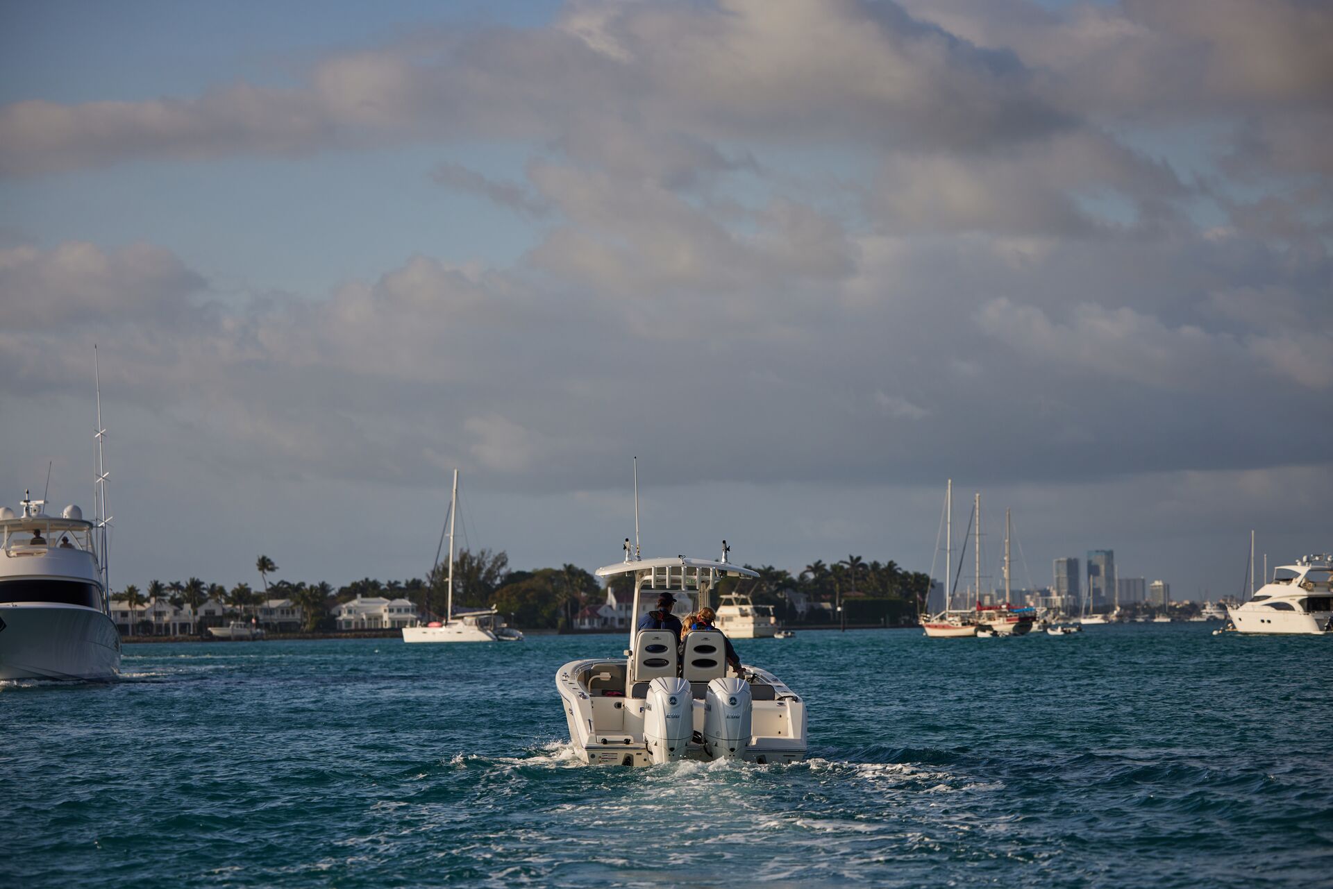 Boat heading toward open water with other boats nearby. 