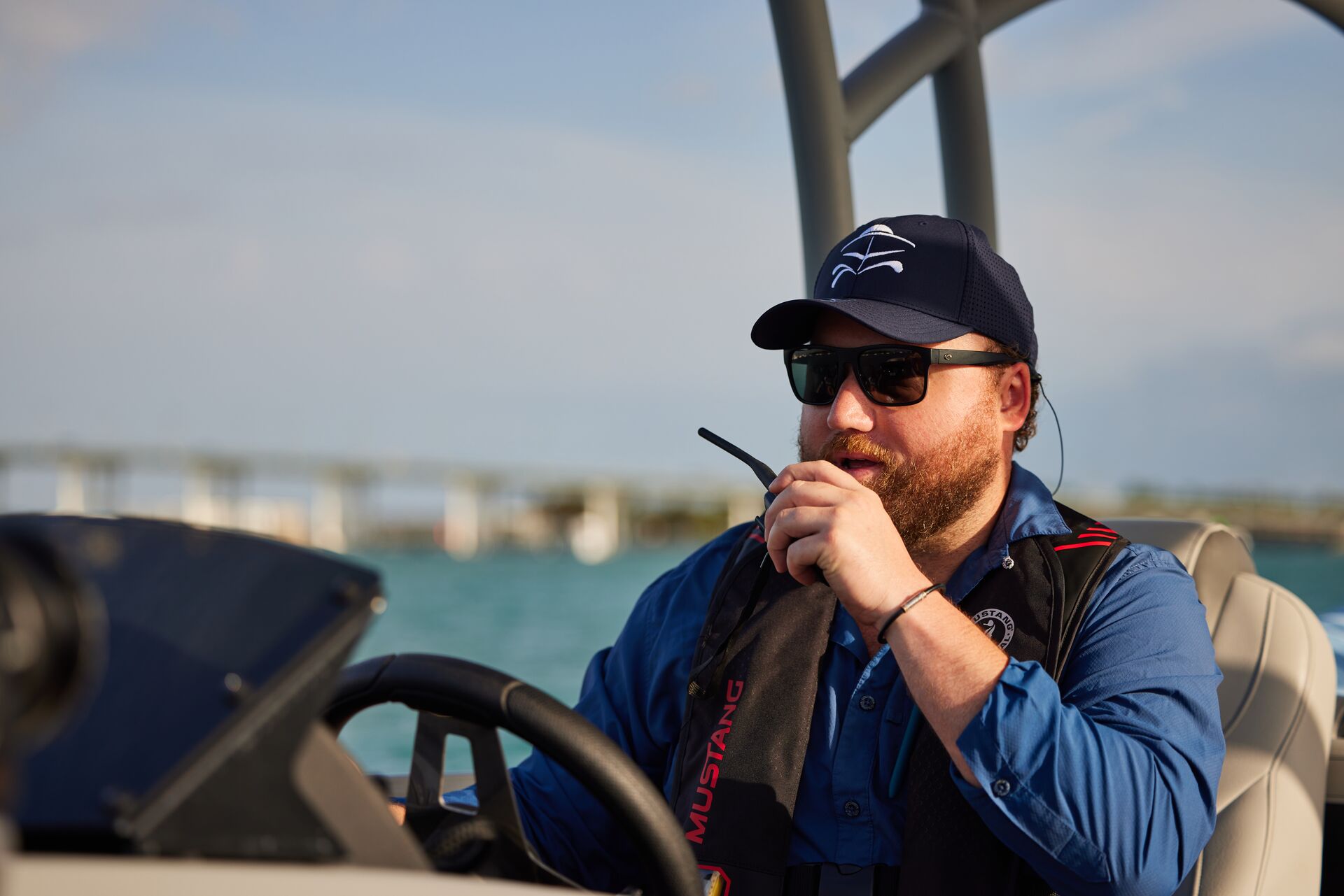 Man uses radio while operating boat, what to do in small craft advisory concept. 