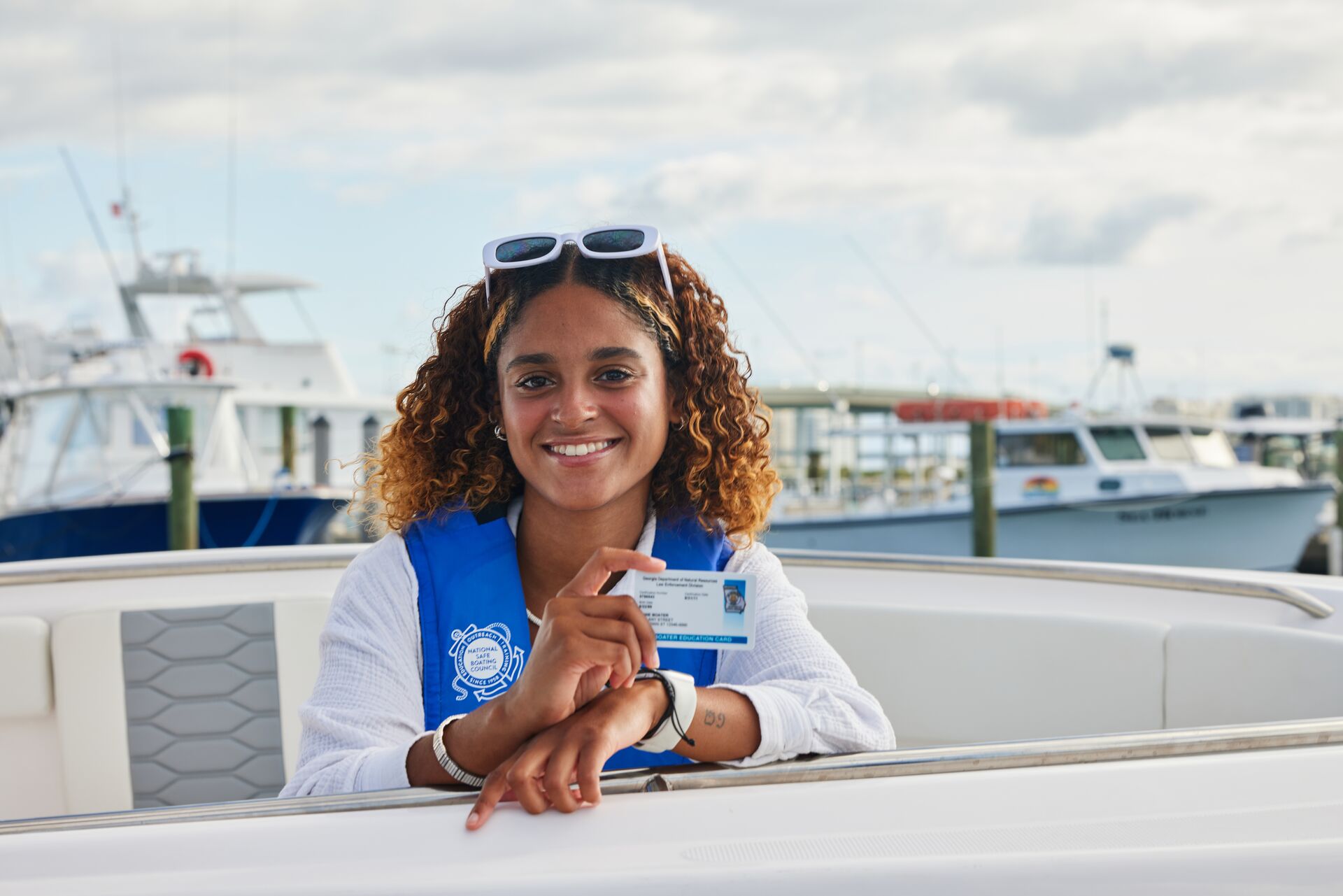 Smiling woman hold boater card, boat license cost US concept. 