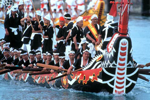 People on a dragon boat at the Stanley Dragon Boat Races.