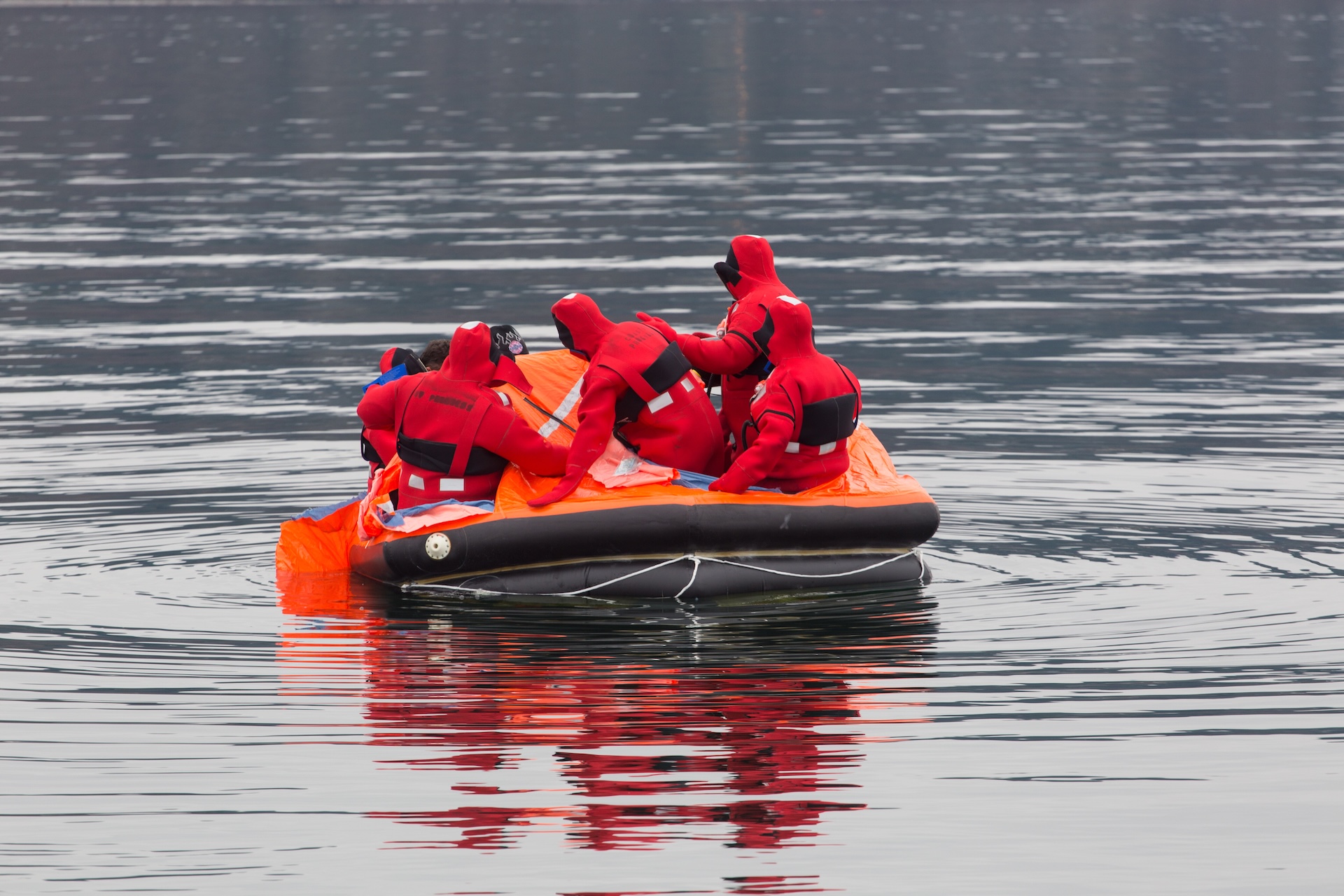 Rescuers in boat on the water, know how to use boat distress flares concept. 