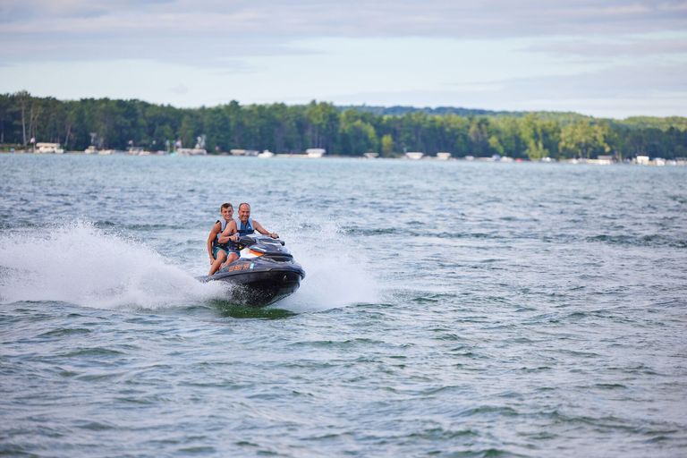 Two people on a jet ski on a lake, British Columbia boating license for jet ski concept.