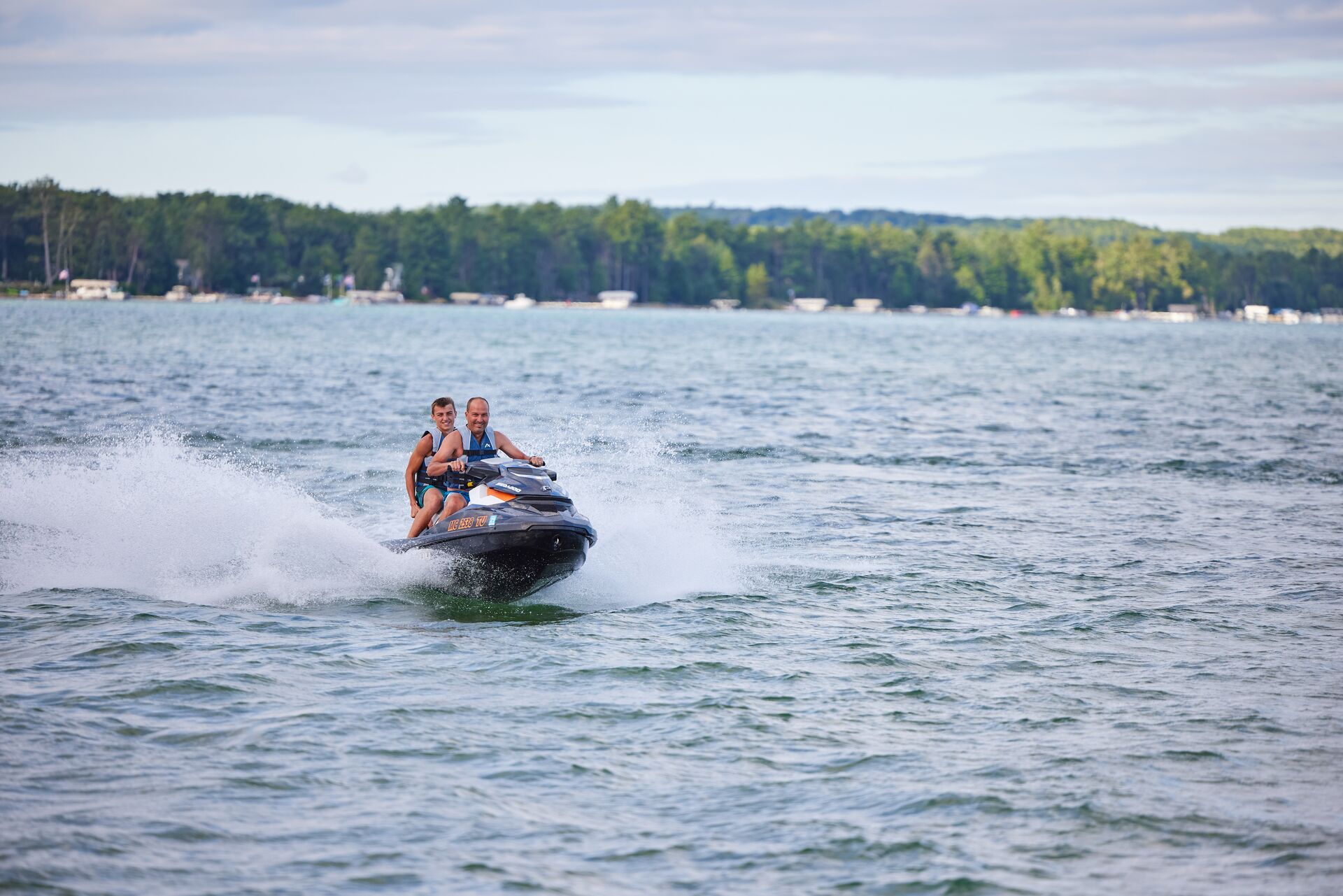 Two people on a jet ski on a lake, British Columbia boating license for jet ski concept. 