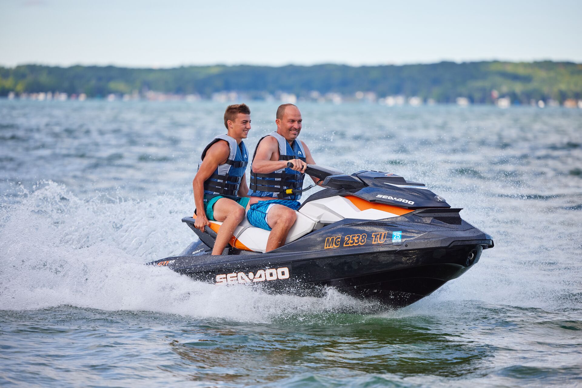 Two jet ski riders on a lake, Alberta boating license for jet ski concept. 