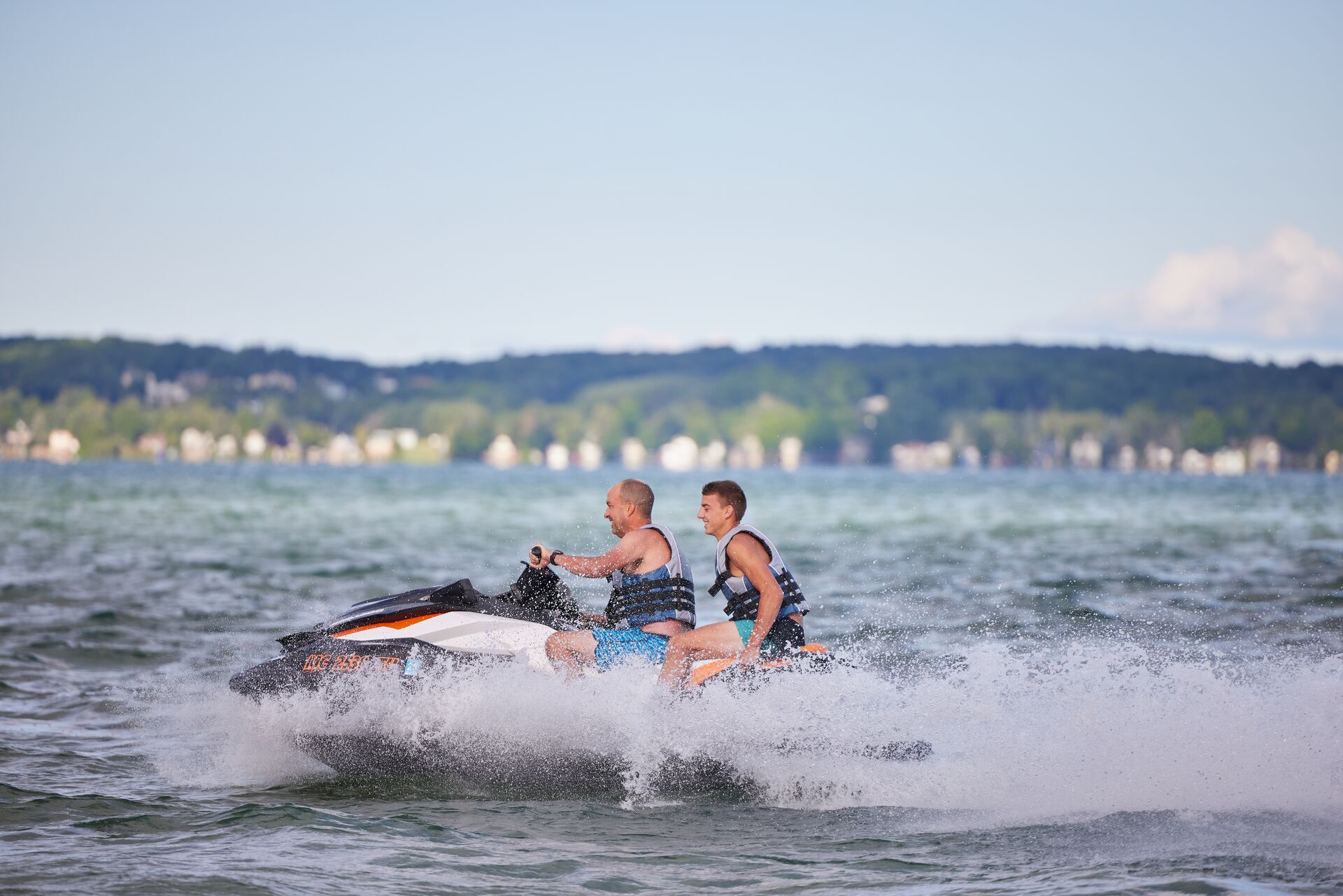 Man and boy jet ski riders, Quebec boating license for jet ski concept. 