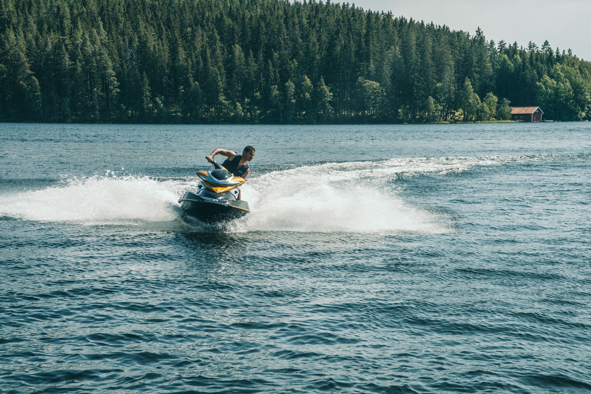 Guy turns a jet ski on the water, boating license for jet ski in Quebec concept. 