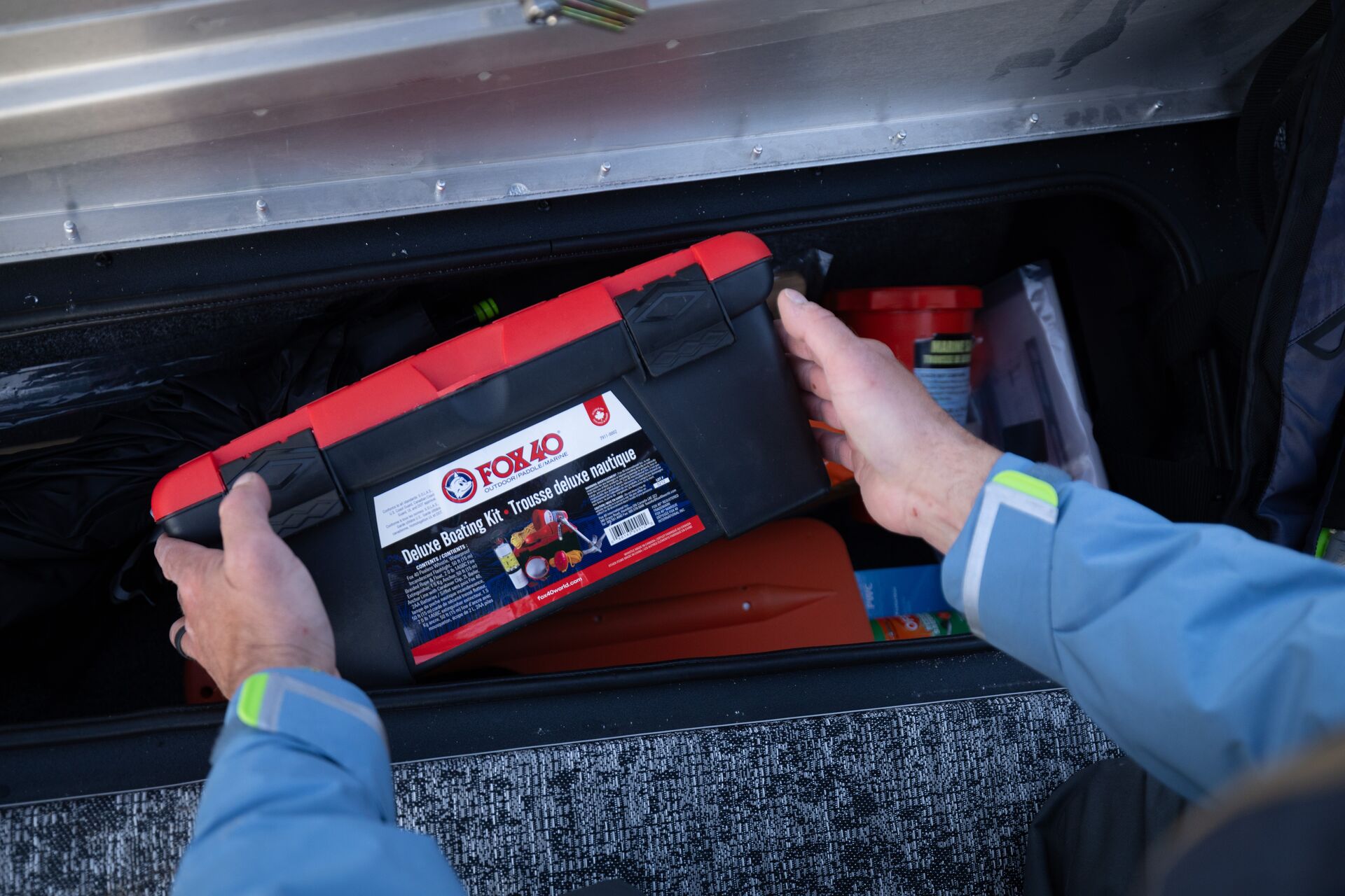 Hands holding a boating box safety equipment, what you learn to take the boating exam Canada concept.