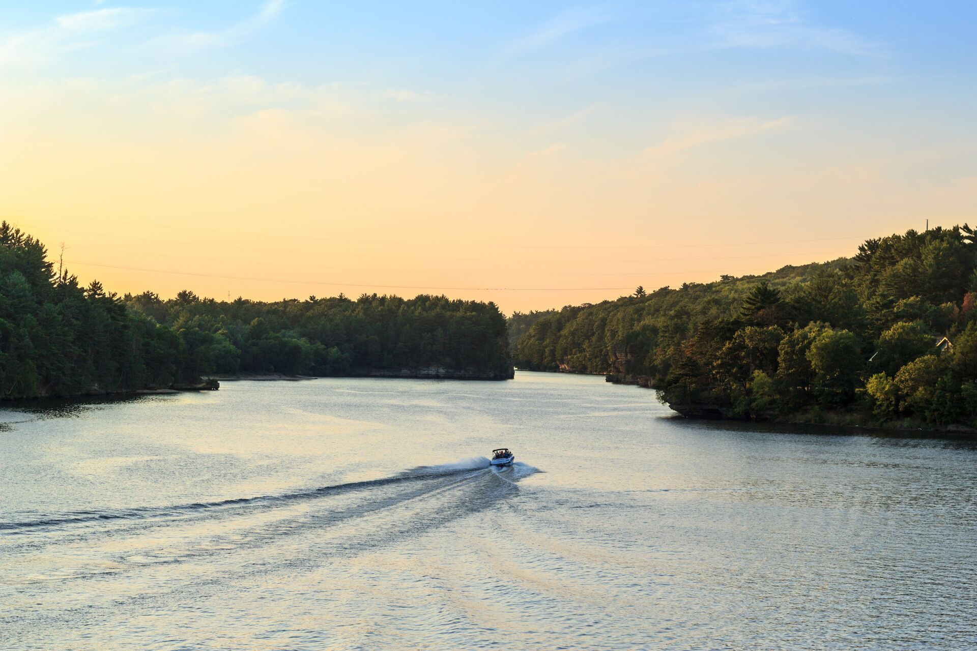 Boat on a waterway in the distance, get your Pleasure Craft Operator Card concept.