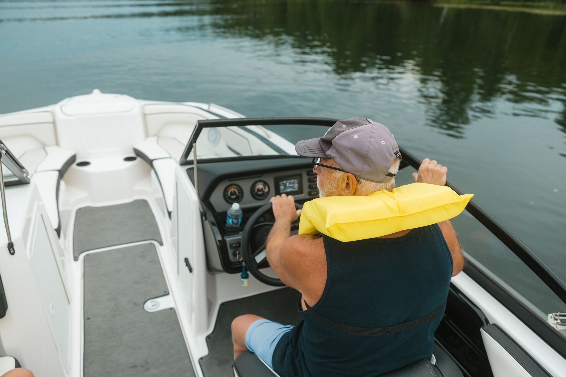 Overhead view of man driving boat, Pleasure Craft Operator Card concept. 