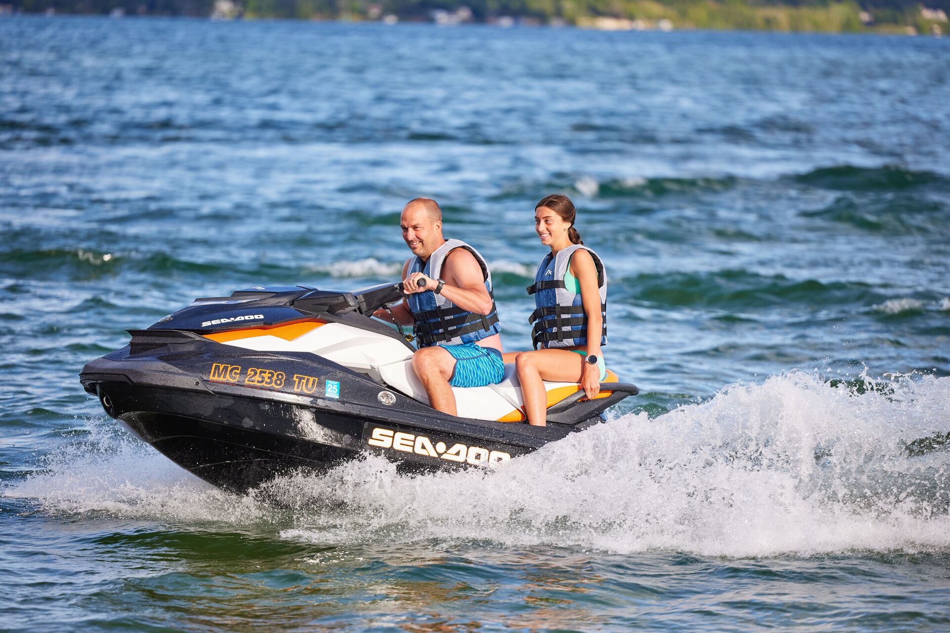 Girl and man ride jet ski, age to operate a pwc Canada concept.