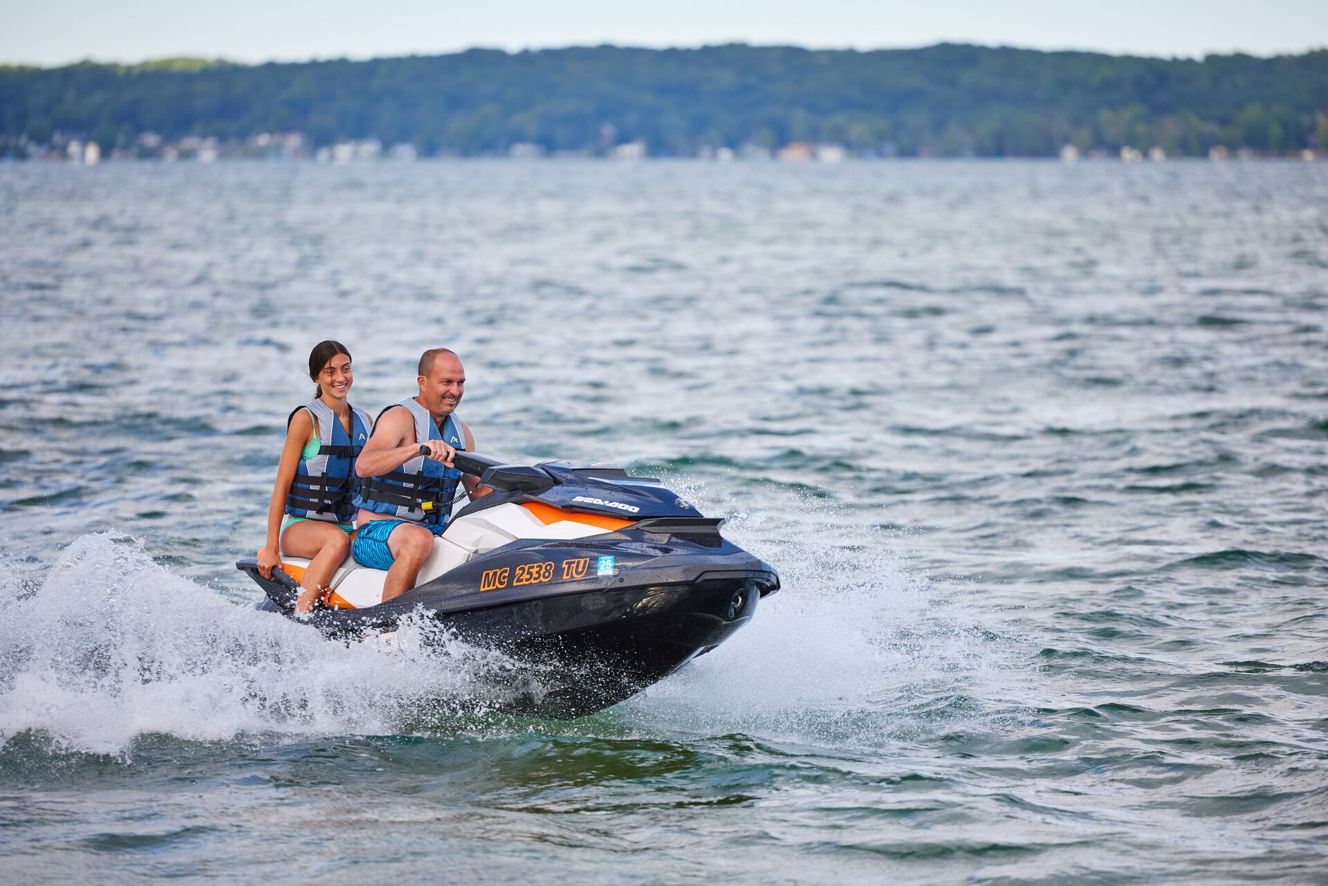 Man and girl riding PWC, do you need a boating license to rent a boat concept. 