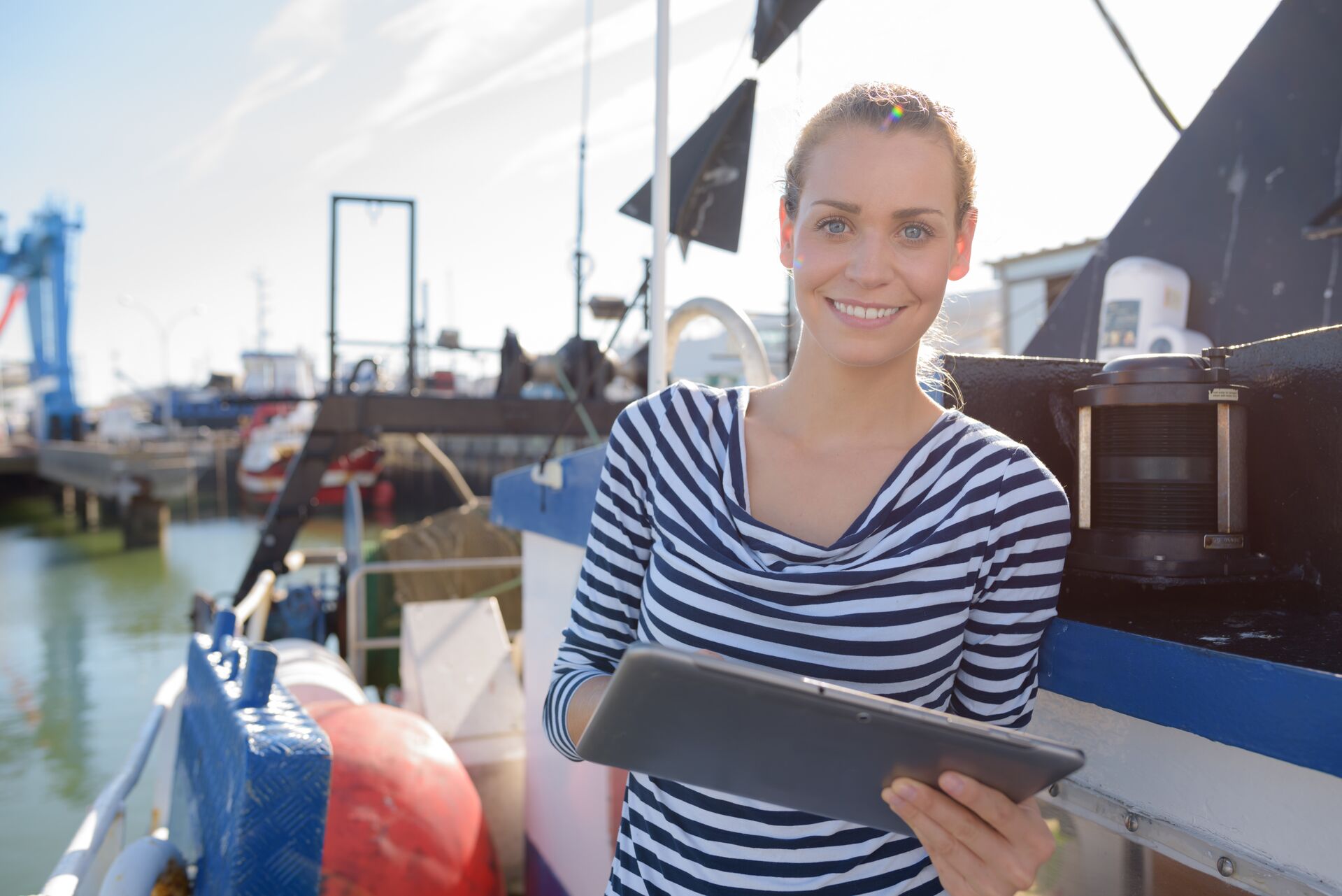 Woman smiles holding tablet, rental safety checklist Canada concept. 
