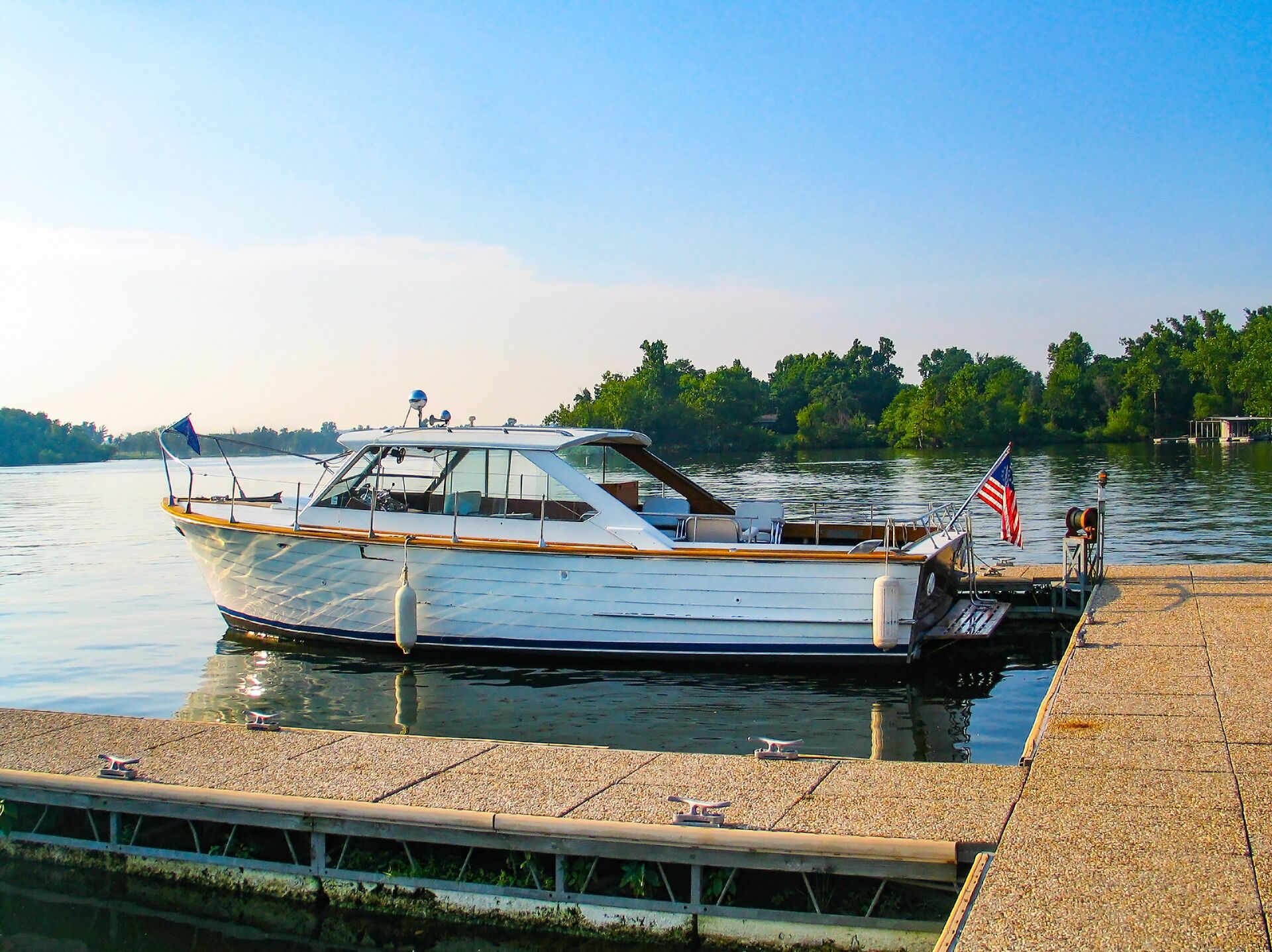 Docked boat displays American flag, do americans need a boating license in canada concept. 