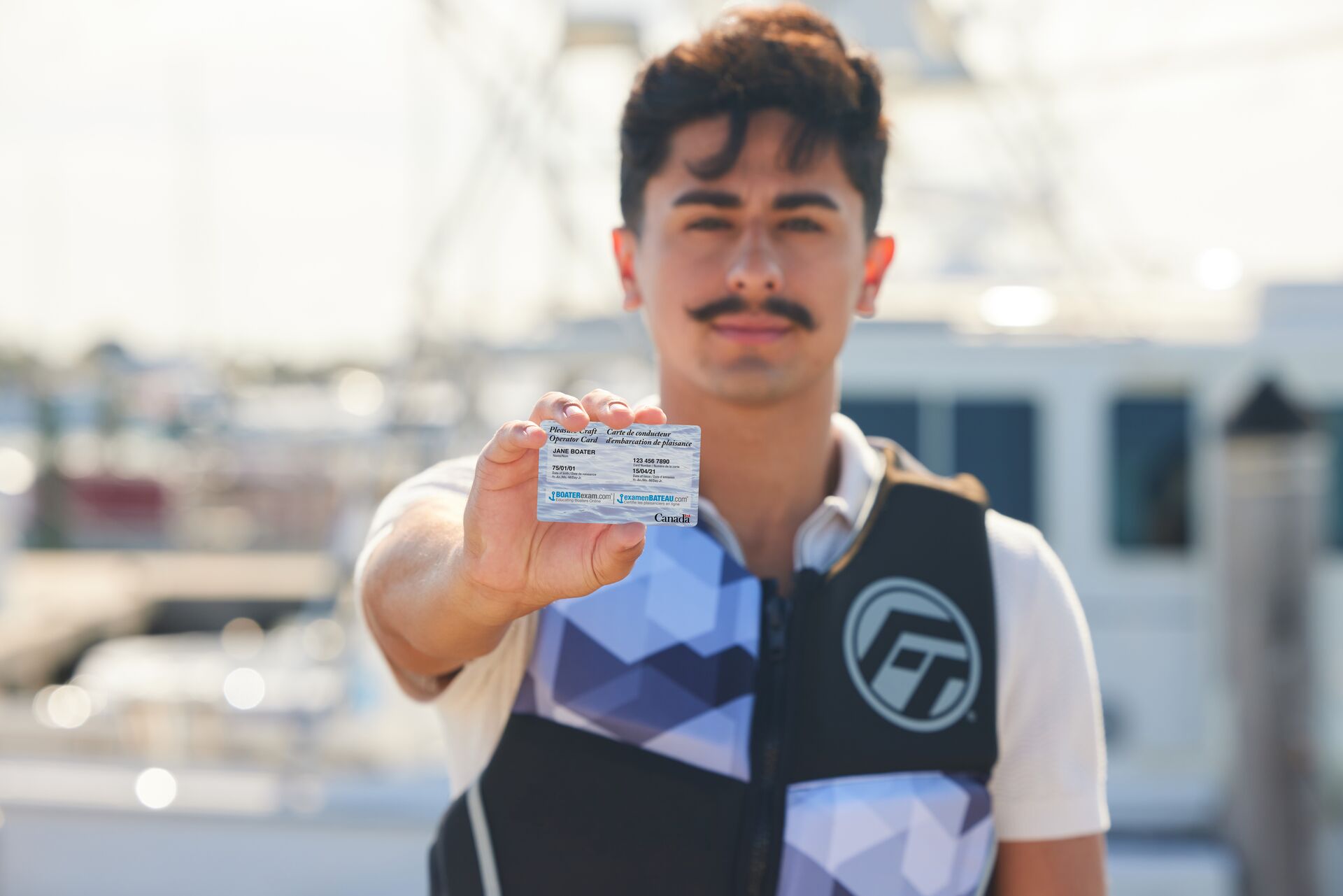 Man holds PCOC, do Americans need a boating license in Canada concept. 