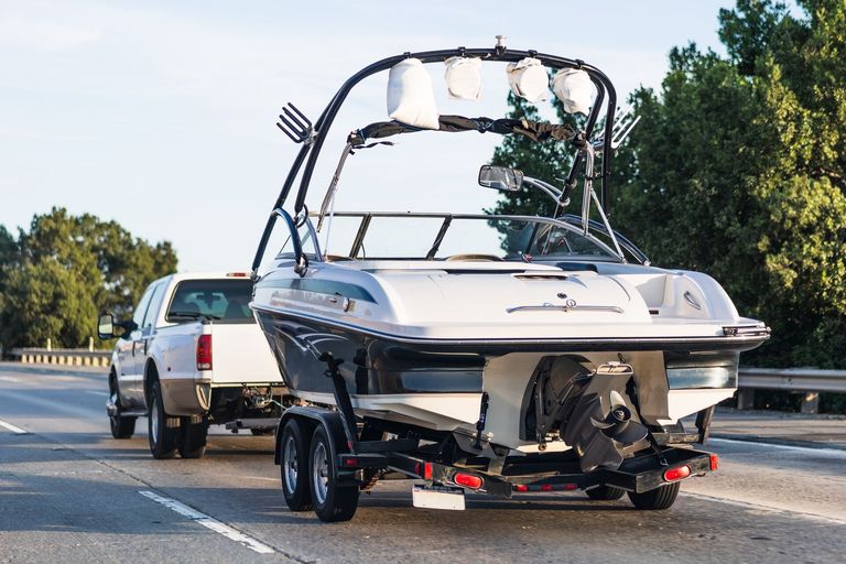 Truck pulls boat on a trailer, boat bill of sale Canada concept. 