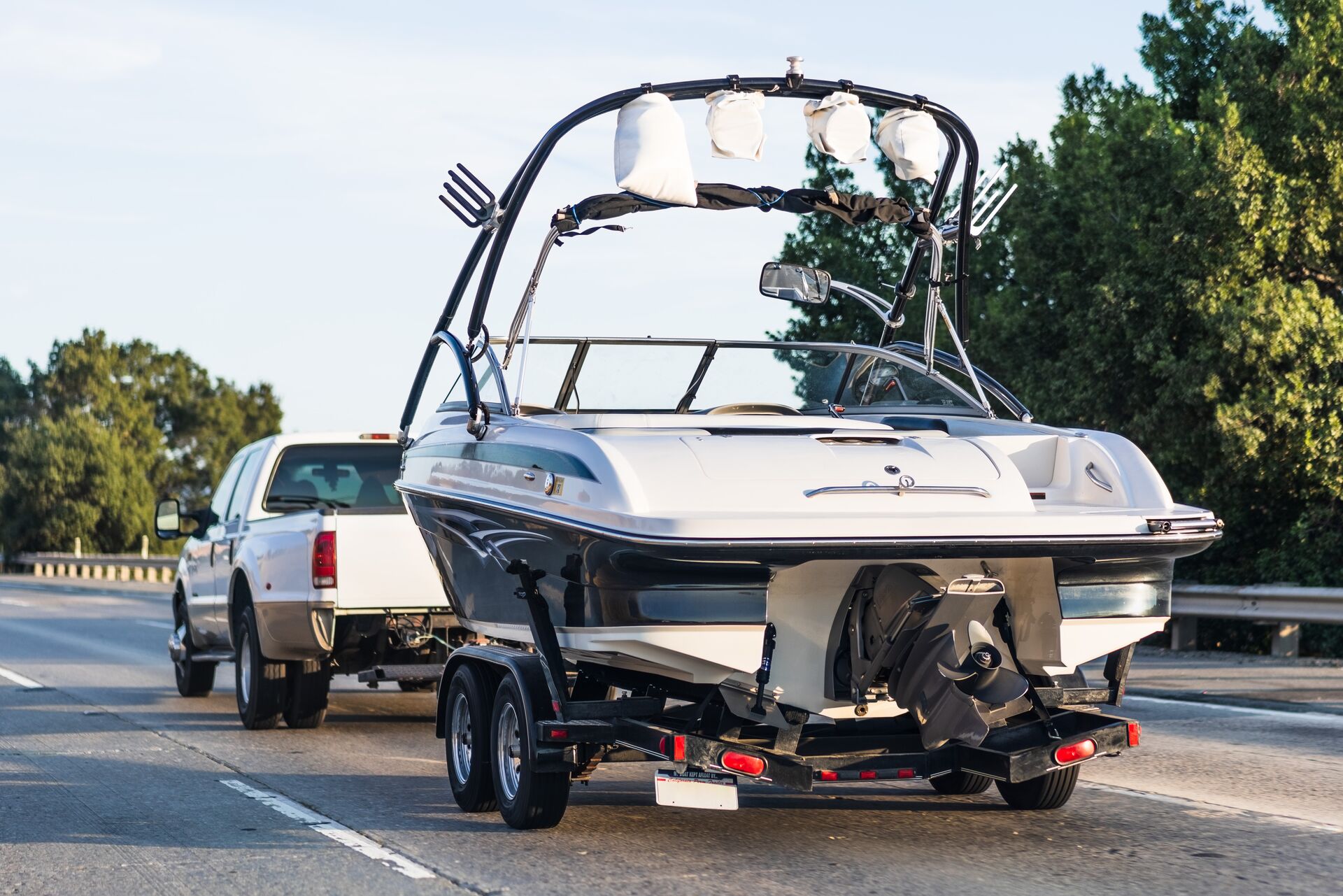 Truck pulls boat on a trailer, boat bill of sale Canada concept. 