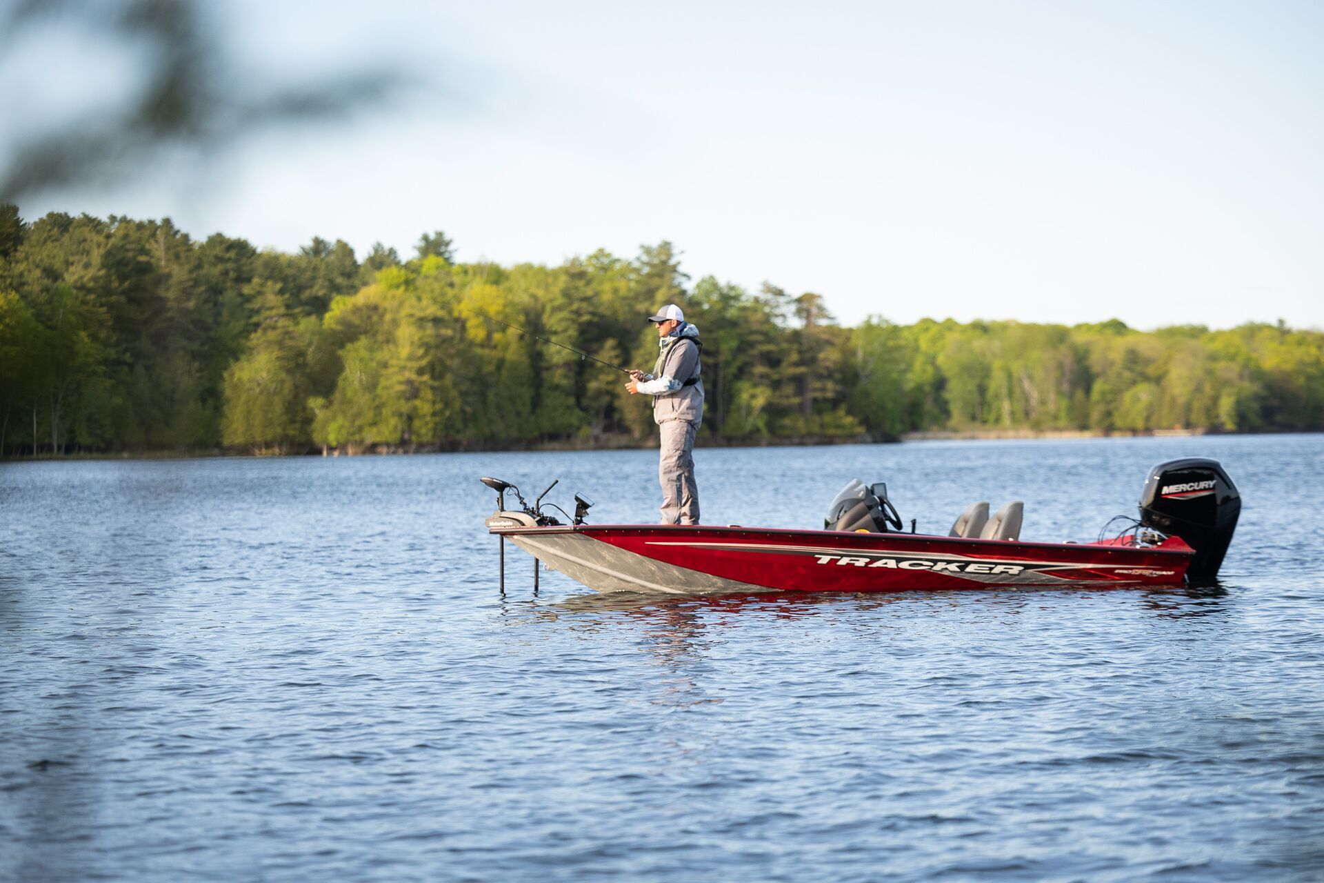 Man fishing from front of boat, fishing licence Alberta concept.