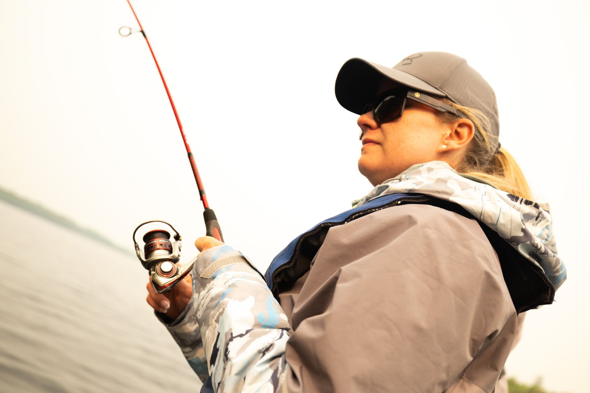Woman with fishing rod and reel, fishing licence Manitoba concept.