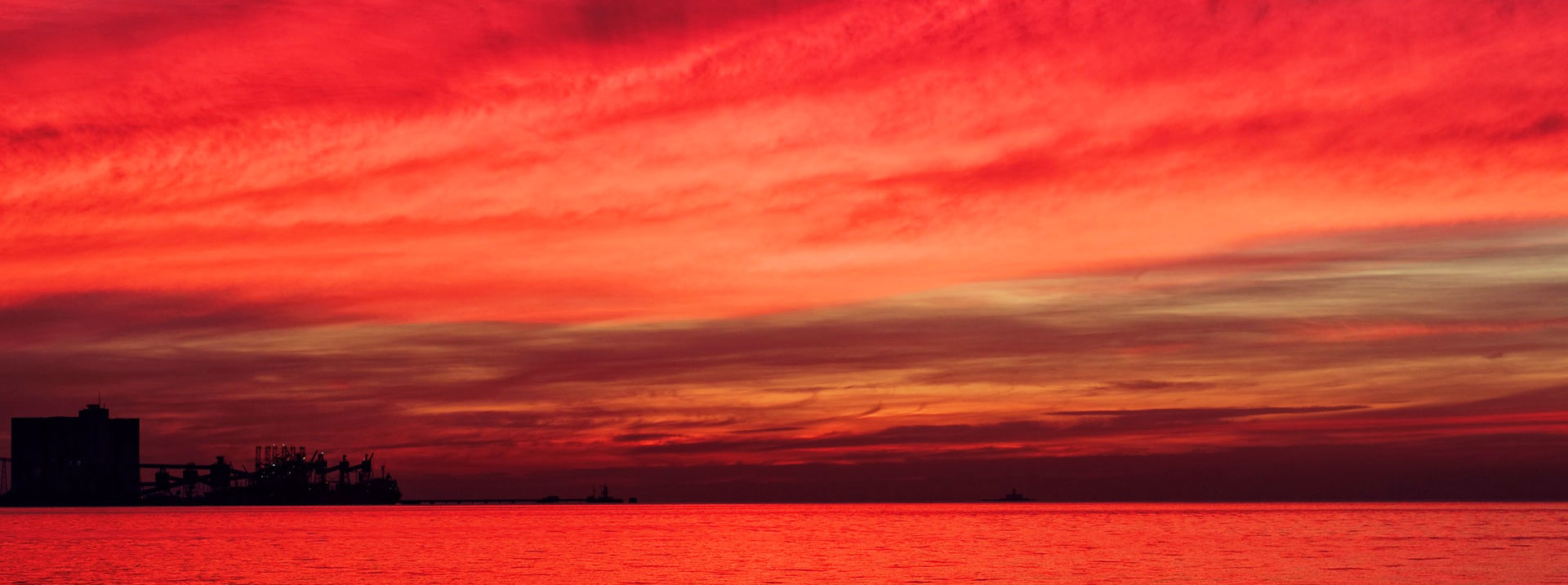 Wide view of a red sky at night, the concept of sailor superstitions.