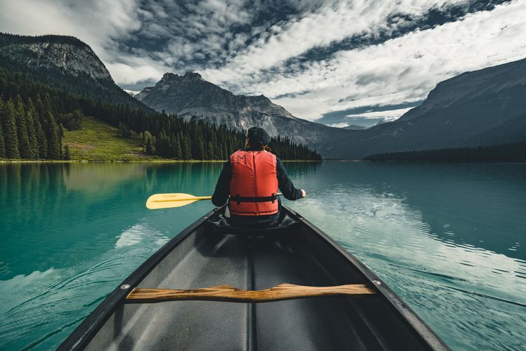 A person in a kayak wearing a lifejacket. 