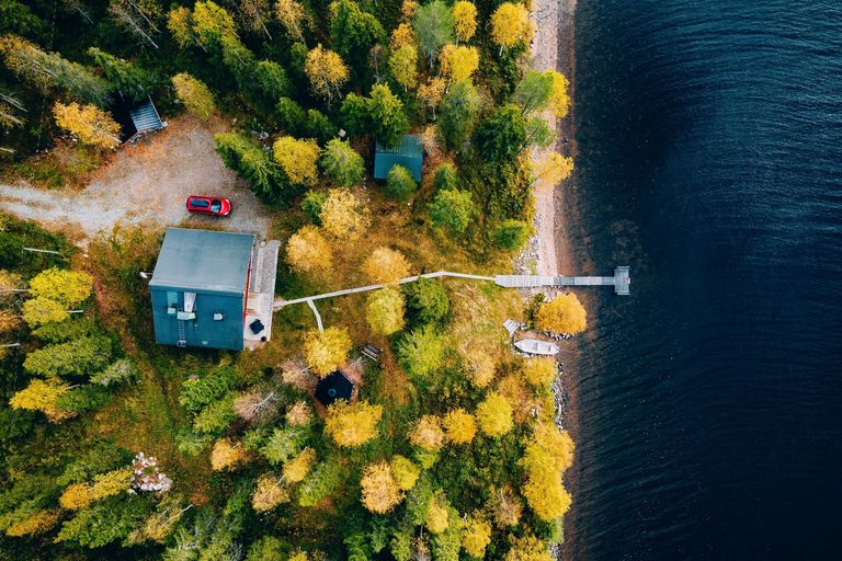 Overhead view of a cottage with a dock on a lake, cottage rules and regulations concept. 