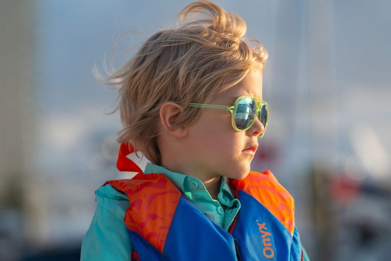 Child wearing a life jacket and sunglasses, Ontario life jacket laws concept. 
